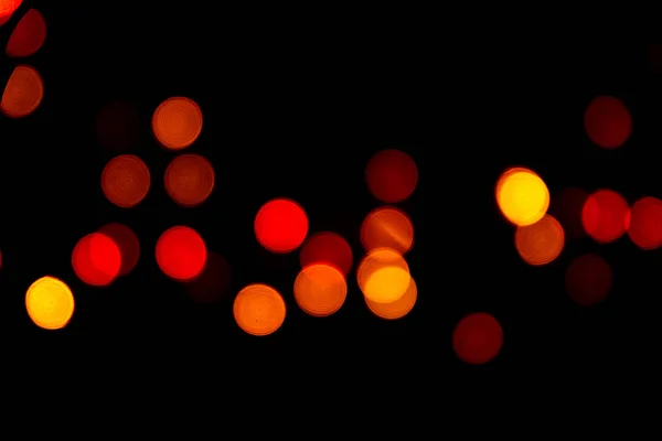 The colorful bokeh on the blurred natural black background.
