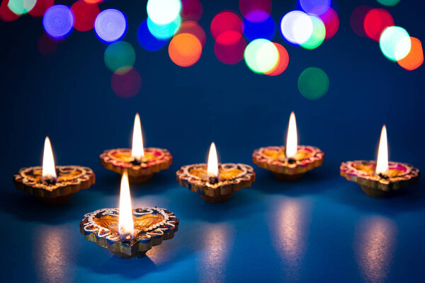 Happy Diwali - Clay Diya lamps lit during Dipavali, Hindu festival of lights celebration