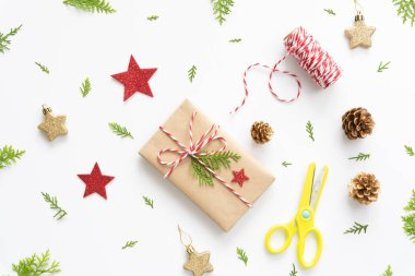 Noel arka plan kavramı. Noel hediye kutusu etiketi mesaj, kırmızı yıldız ve çam kozalakları ile üstten görünüm beyaz arka plan üzerinde.