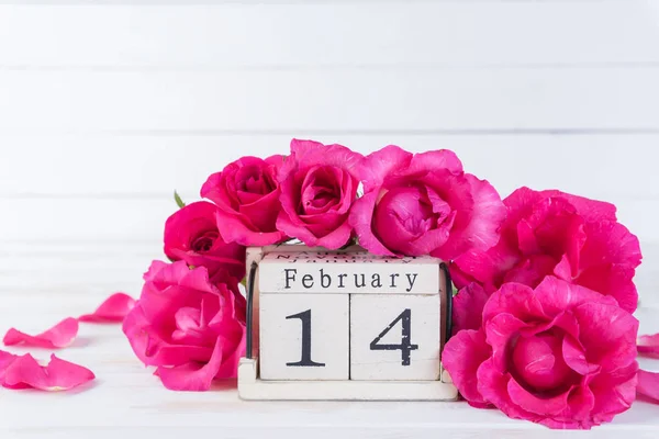 情人节和爱情的概念 粉红色玫瑰与2月14日文本在木块日历在白色木制背景 — 图库照片