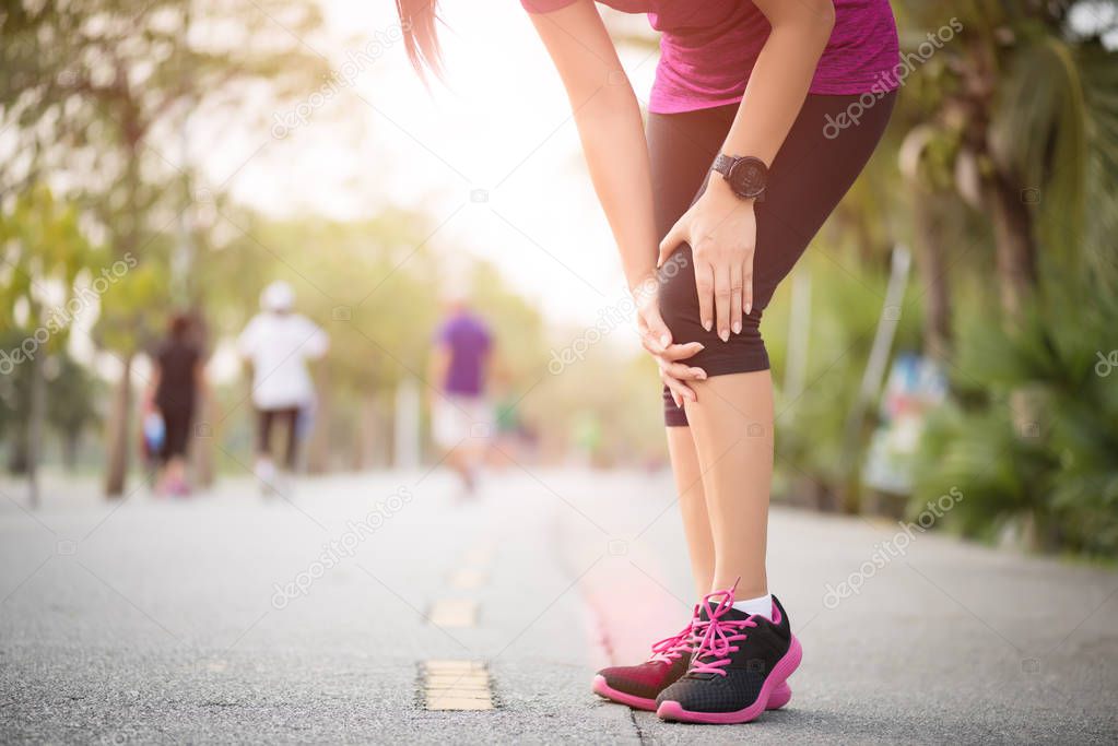 Runner sport knee injury. Woman in knee pain while running work 