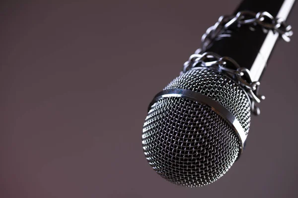 Microphone with a chain, depicting the idea of freedom
