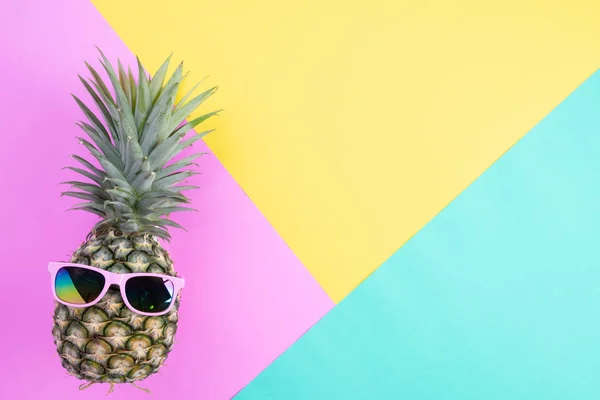Beach accessories pineapple with pink sunglasses on pink