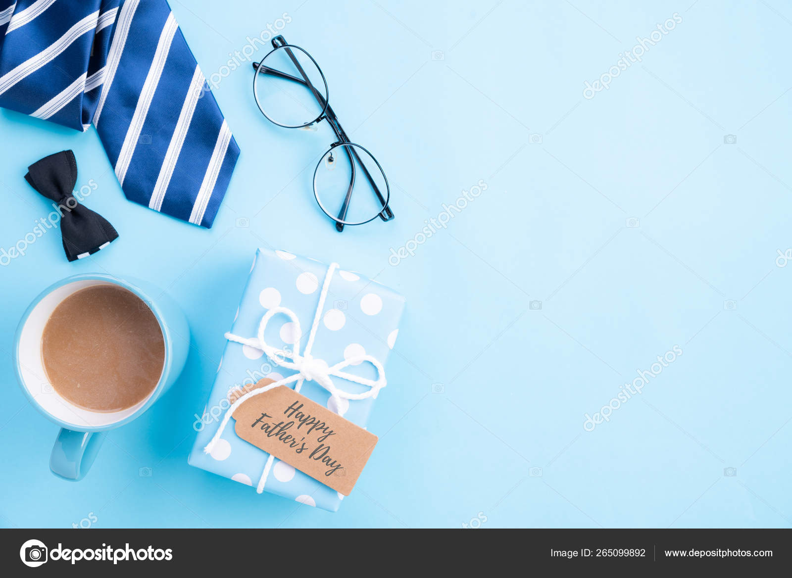 Happy fathers day concept. Top view of blue tie, beautiful gift box, coffee  mug, glasses with LOVE DAD text on bright blue pastel background. Stock  Photo by ©spukkato 265099892