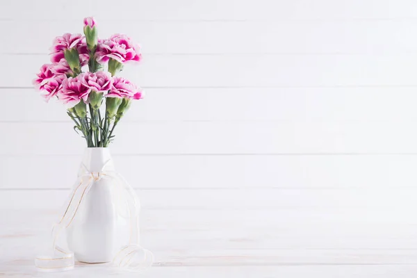 Dia dos Namorados e conceito de amor. Flor de cravo rosa em vaso no fundo de madeira branco . — Fotografia de Stock