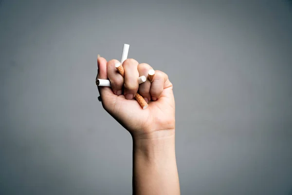 World No Tobacco Day, May 31. STOP Smoking. Close up Man hand crushing and destroying cigarettes on gray background. — Stock Photo, Image