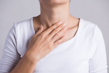 Sore Throat. Closeup Of Beautiful Young Woman Hand Touching Her Ill Neck. Healthcare and medical concept. clipart