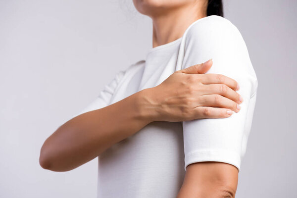 Closeup woman holds her arm injury, feeling pain. Health care and medical concept.