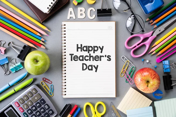 Happy teacher\'s day and Education or back to school Concept. Top view of Colorful school supplies with books, color pencils, calculator, pen cutter clips and green apple on gray background. Flat lay.