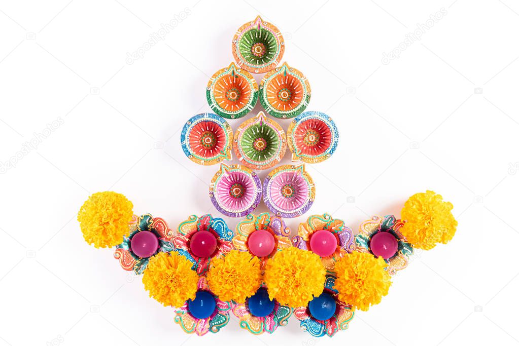 Happy Diwali - Clay Diya lamps lit during Dipavali, Hindu festival of lights celebration. Colorful traditional oil lamp diya on white background