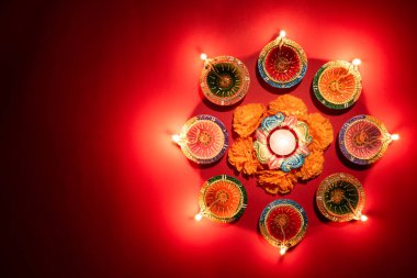 Mutlu Diwaliler - Dipavali sırasında Clay Diya lambaları yandı, Hindu ışık festivali kutlaması. Pembe arka planda renkli geleneksel gaz lambası diya