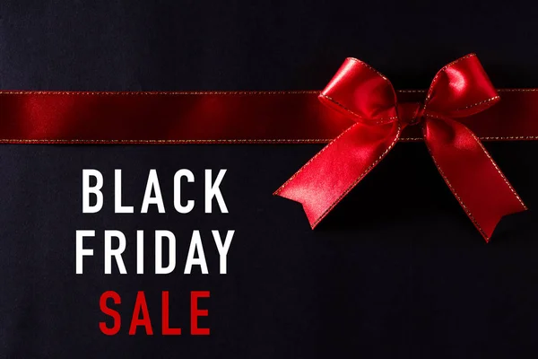 Top view of red ribbon on black background with copy space for text. black Friday and Boxing Day composition. — ストック写真