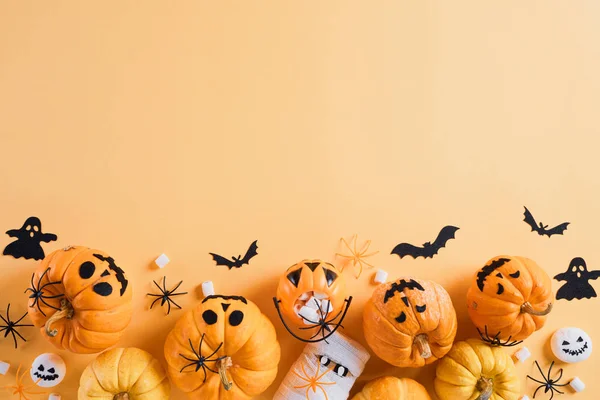 Vue de dessus de l'artisanat d'Halloween, citrouille orange, fantôme blanc, chauve-souris et araignée sur fond orange avec espace de copie pour le texte. concept halloween. — Photo
