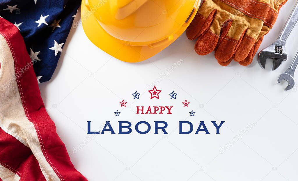 Happy Labor day concept. American flag with different construction tools on white background, with copy space for text.