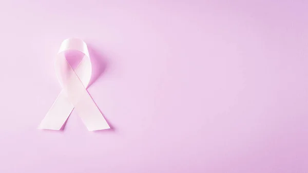 Pink ribbons sign for breast cancer awareness. Symbolic bow color raising awareness on women's breast tumor. Healthcare, medicine and breast cancer awareness concept.