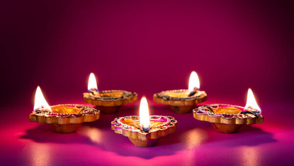 Happy Diwali - Clay Diya lamps lit during Dipavali, Hindu festival of lights celebration
