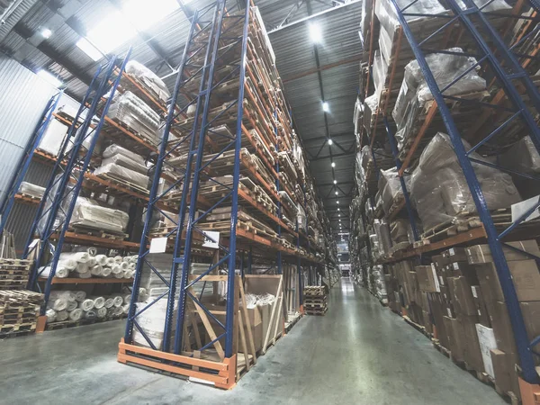 Équipement logistique, Grand hangar entrepôt avec des étagères de lots ou des rayonnages avec des palettes de marchandises. Expédition industrielle et fret — Photo