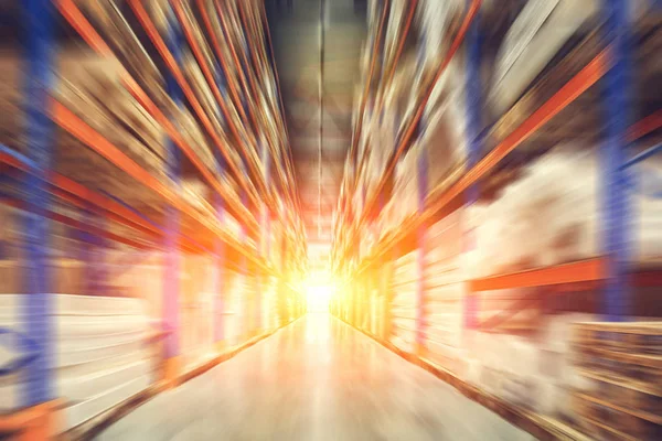 Large modern industrial logistic warehouse in motion blur and sunlight effect, abstract cargo distribution storage