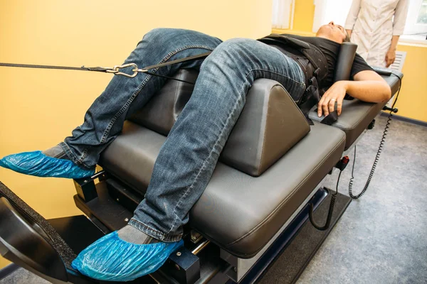 Male patient at non-surgical treatment physiotherapy of lumbar spine and spinal cord dilatation in medical center — Stock Image Male patient at non-surgical treatment physiotherapy of lumbar spine and spinal cord dilatation in medical center Royalty Free Stock Photos