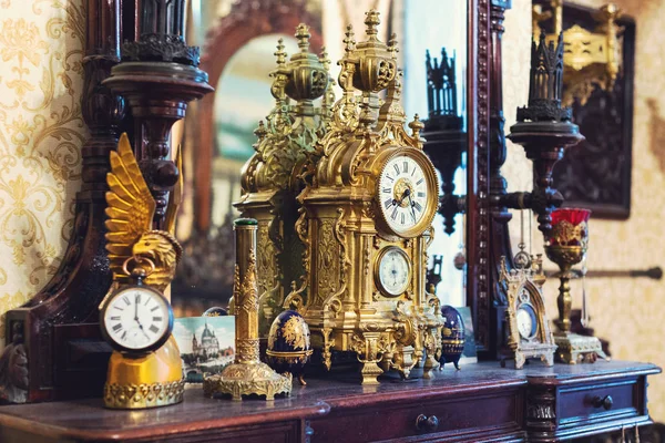 Old vintage antique bronze clock and utensil on wooden shelf, Antiques concept — Stock Photo, Image