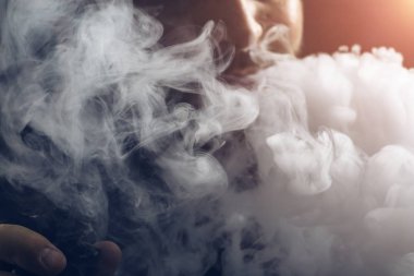 Dostum vape e-sigara ile e-sıvı, yakın çekim, buhar ya da buhar büyük bulutu nefes. Vaping kavramı, ışık efekti