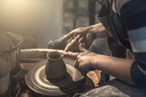 Female potter works with clay on pottery wheel, craftsman hands close up — Stock Photo, Image