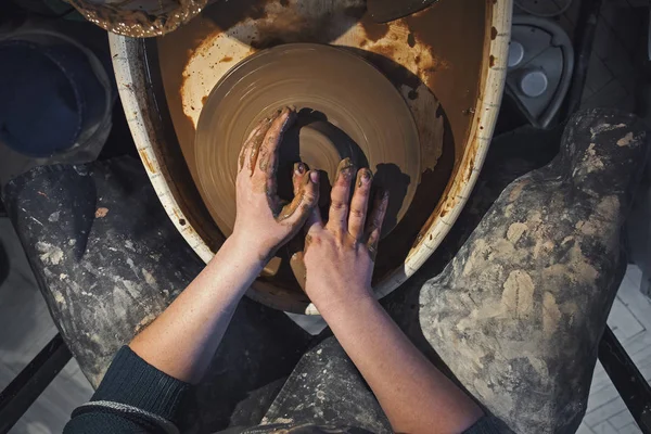 Female potter works with clay on pottery wheel, craftsman hands close up — Stock Photo, Image