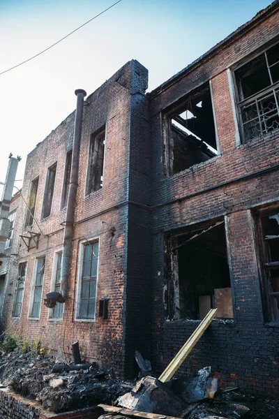 Abandoned burned out industrial brick building exterior, vertical image