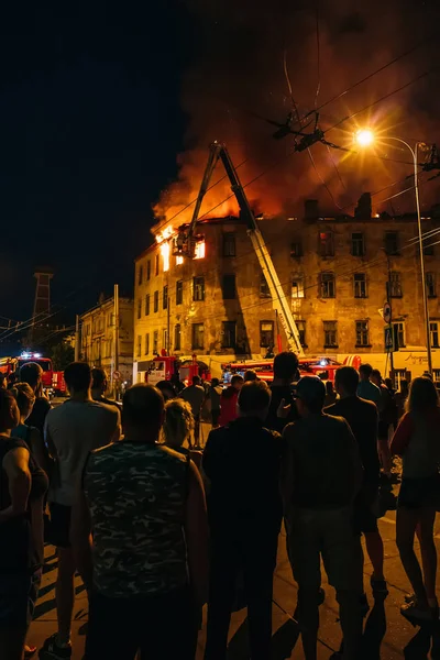 Rybinsk, Rusya Federasyonu-31 Temmuz 2018: insanlar gece yangın dairesinin olduğu binanın, alev ile itfaiye mücadele stand çevresinde