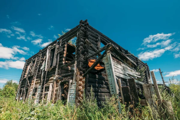 Gebranntes Holzhaus nach Brand, zerstörtes Gebäude, Katastrophe oder Kriegsfolgen — Stockfoto