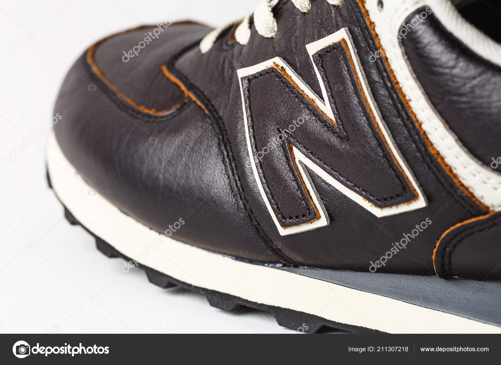 Moscow, Russia - Circa August 2018 : New Balance Shoes logo - N on new leather New Balance - American manufacturer of sportswear – Stock Editorial © DedMityay #211307218