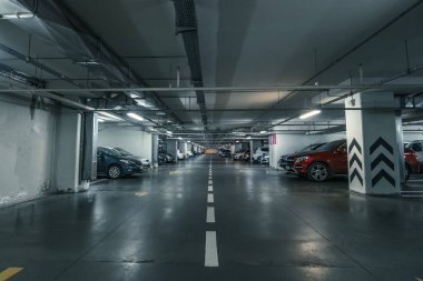 Yeraltı araba park garaj modern alışveriş merkezi veya alışveriş merkezi içinde birçok otomobil ile sütunlarla büyük salonu