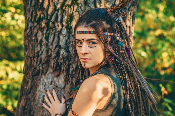 Portrait of young girl in image of Native American, close up, young attractive woman warrior looks at camera — Stock Photo, Image