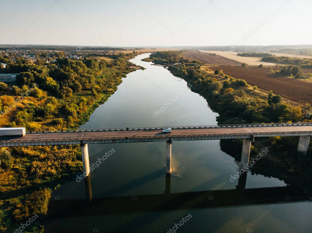 Aerial view of bridge over Don river in Voronezh, autumn landscape from above view with highway road and car transportation