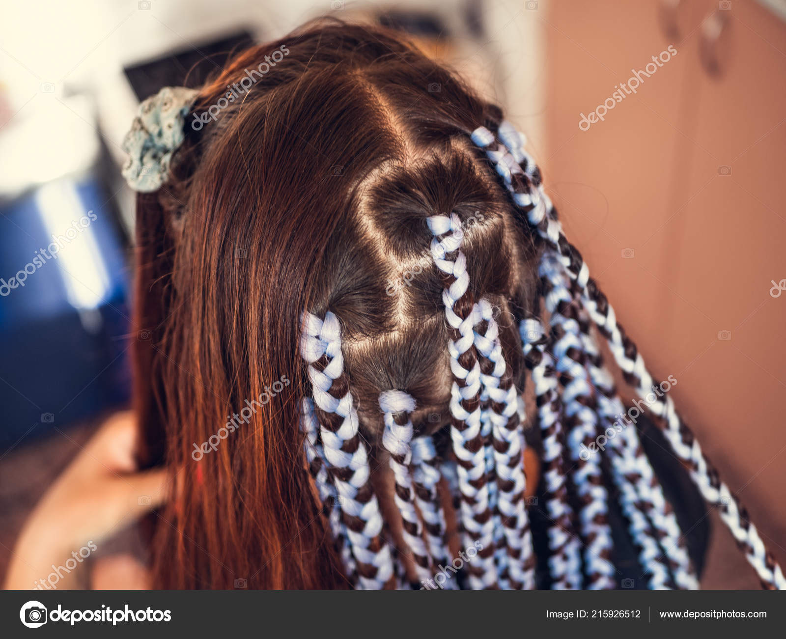 Hairdresser Weaves Braids With Kanekalon Material To Young Girl
