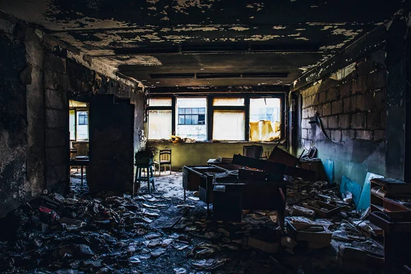 Burnt house interior. Burned room in industrial building, charred furniture and damaged apartment after fire — Stock Photo, Image