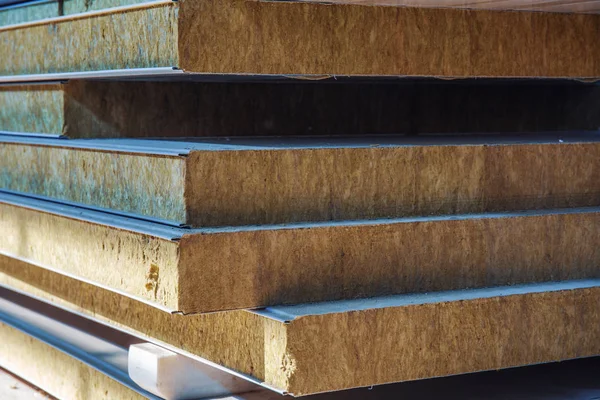 Stack of modern sandwich panel blocks from metal profile and wool foam for building warm and sound protected houses