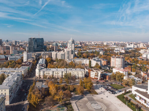 Aerial drone shot of Voronezh downtown with buildings from above, parks, streets with cars in sunny autumn day
