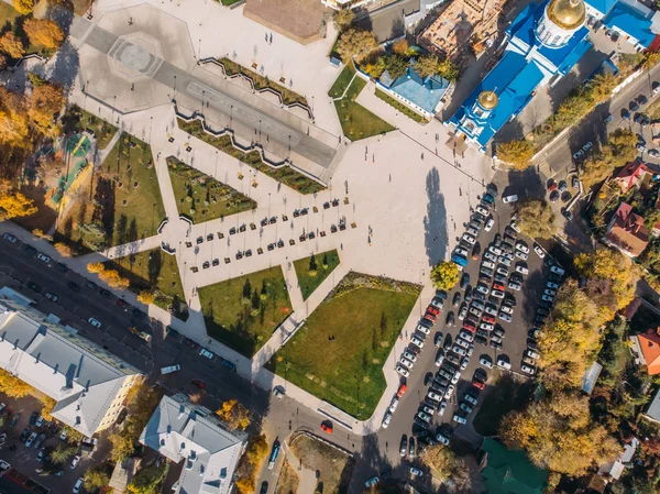 Vue de dessus du drone au-dessus du parc avec pelouses vertes et parking avec des voitures dans le centre de la ville moderne, prise de vue aérienne — Photo