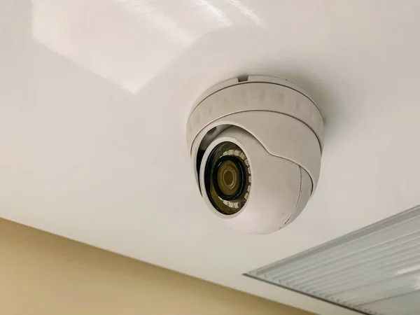 Security CCTV camera at ceiling in train corridor inside