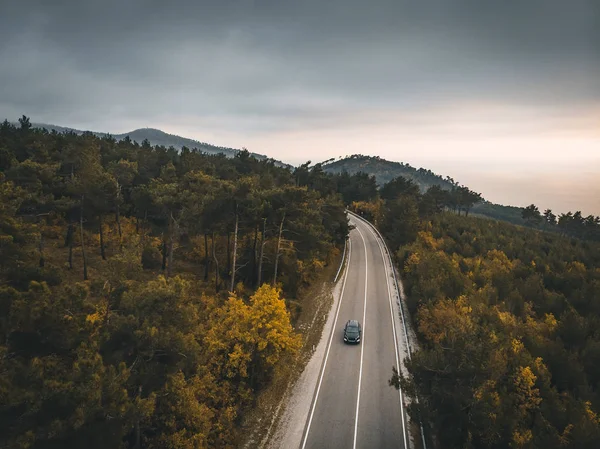 Veduta aerea di auto su strada asfaltata di montagna di autunno, viaggiare in Europa sul concetto di trasporto, colpo drone con spazio copia — Foto Stock