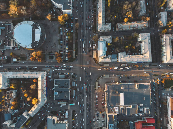 Road traffic on crossroad or intersection downtown of European city, aerial or top view, toned