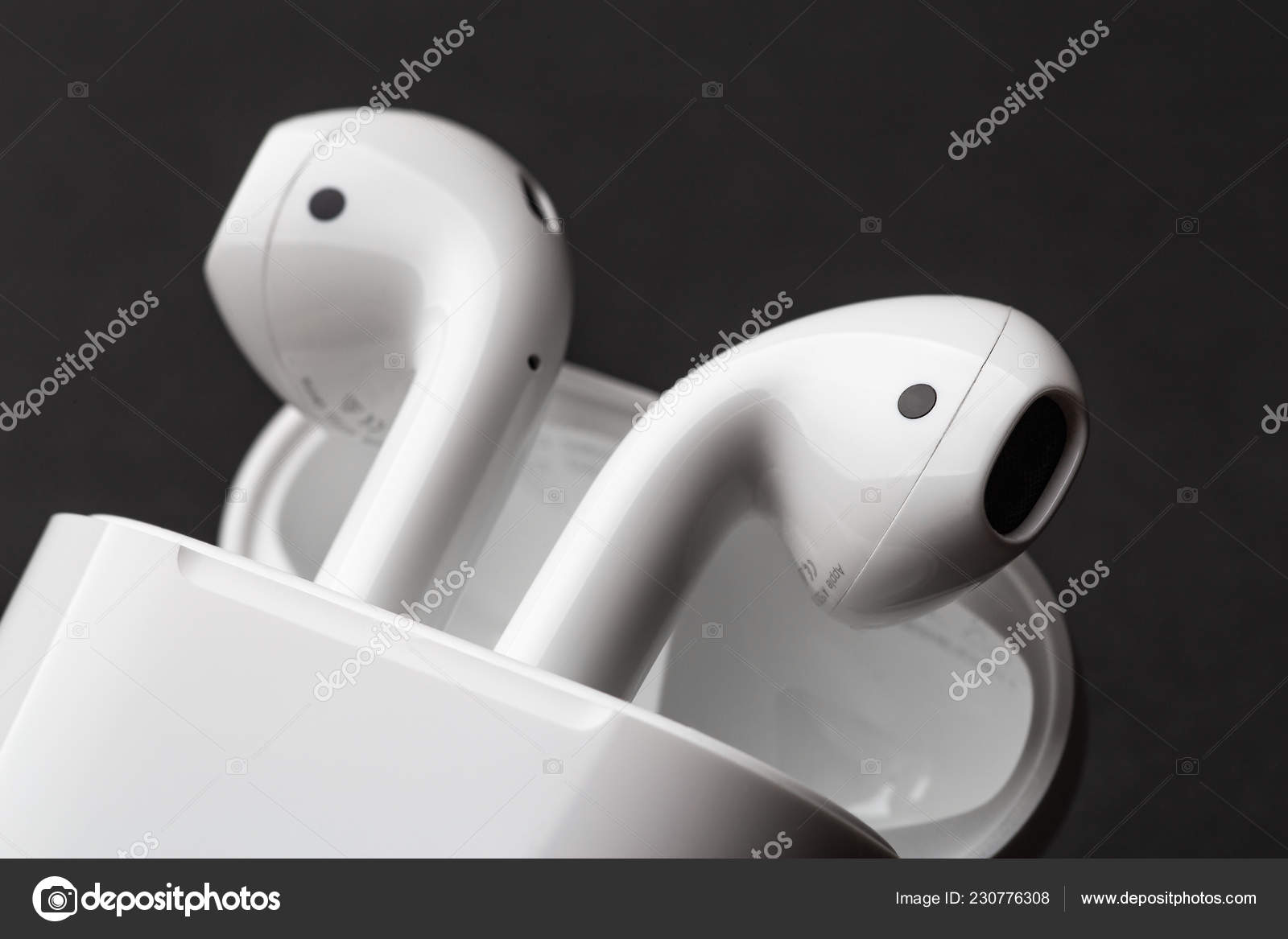 Moscow, Russia - Circa December 2018: Apple AirPods - wireless bluetooth earphones or headphones and white box storage and charging, use Ipad or Mac – Stock Editorial Photo © DedMityay #230776308