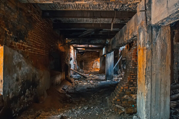 Dark tunnel or corridor im abandoned industrial building inside, toned