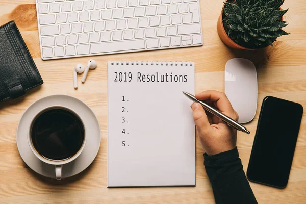 2019 Resolutions - text on notebook at work place top view, check list or plan of business strategy for motivation and inspiration — Stock Photo, Image