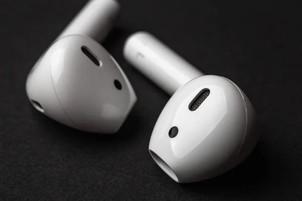 White wireless bluetooth earphones or headphones, close up