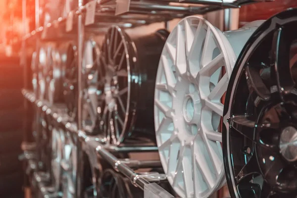 Car rims or wheels in store, rows of new alloy automobile disks