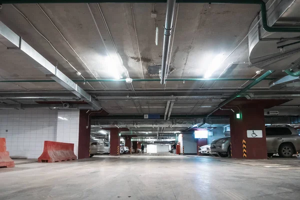Estacionamento subterrâneo iluminado garagem interior sob shopping moderno com lotes de veículos — Fotografia de Stock