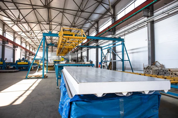 Mesin konveyor otomatis baris atau sabuk untuk roll logam membentuk di interior pabrik industri sebagai latar belakang industri — Stok Foto