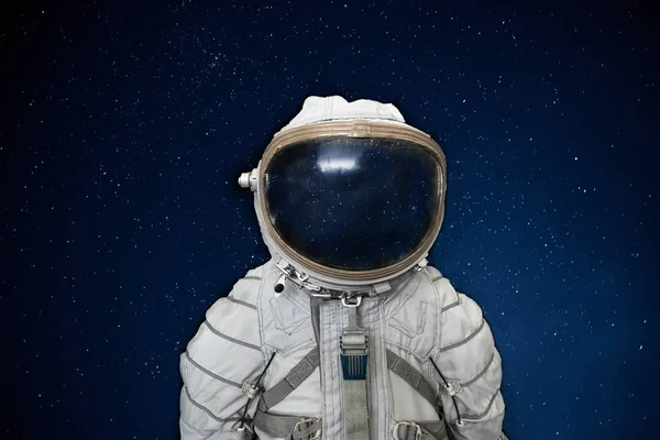 Soviet cosmonaut or astronaut or spaceman suit and helmet on black space with stars background